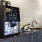 a kitchen with a black refrigerator
