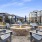 a patio with benches and a fire pit in front of a building