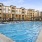 Dog-Friendly Apartments in Charlotte - Accent Southrail - Pool with Lounge Chairs, Wadding Chairs, and Umbrellas.